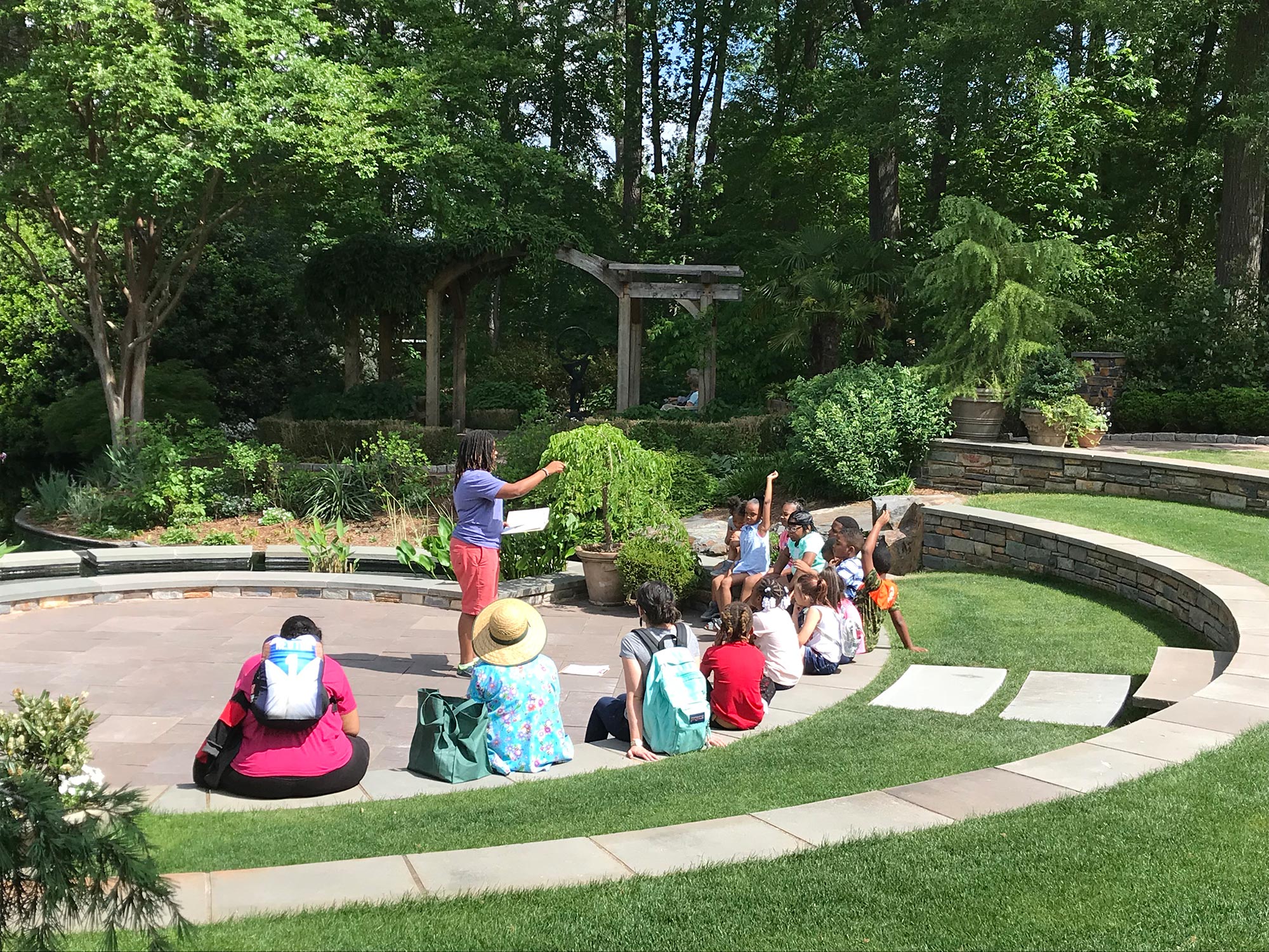 Sam Aldave teaches a small group of children in the Angle Amphitheater