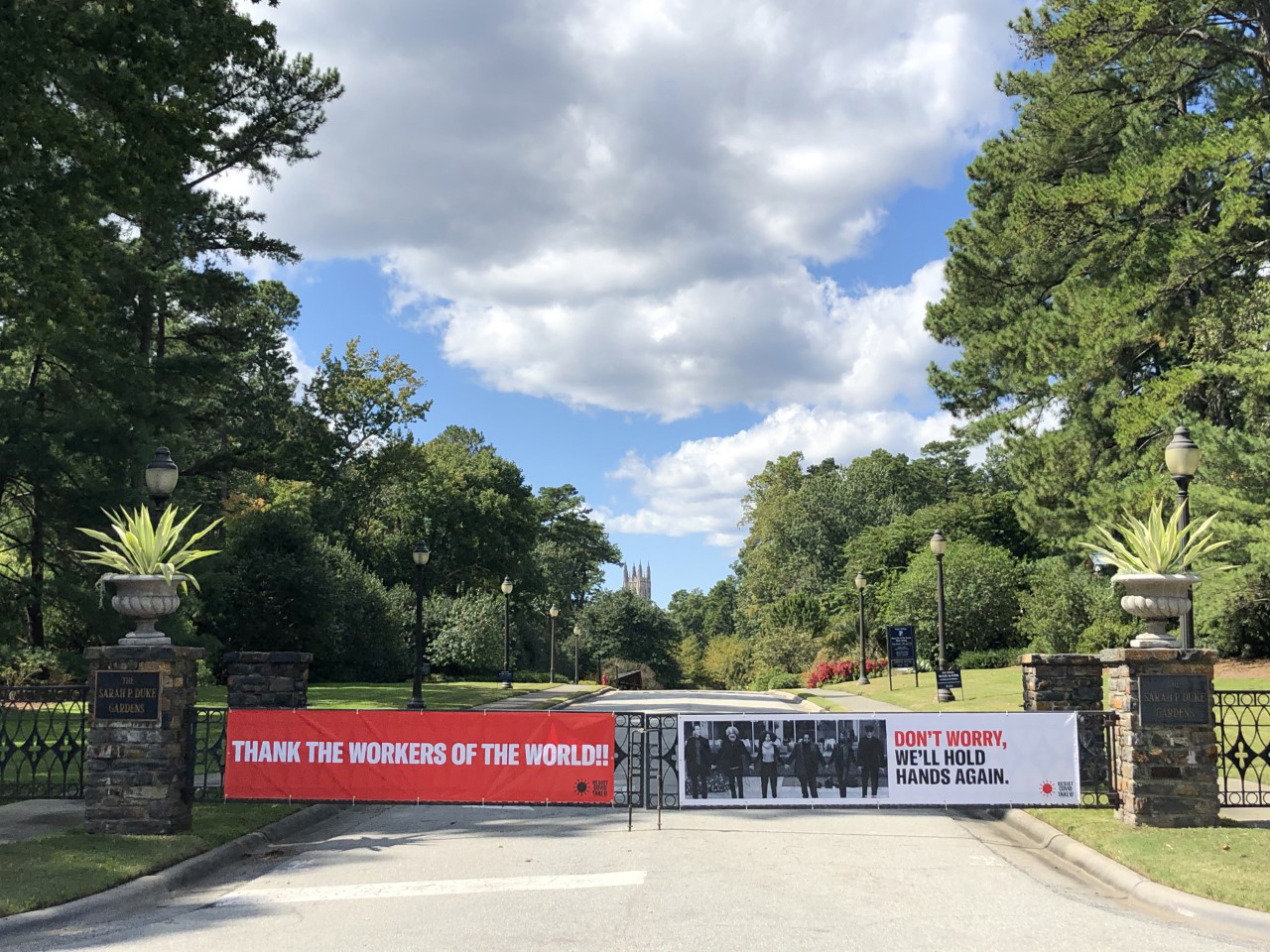 two long banners attached to the main gates of Duke Gardens